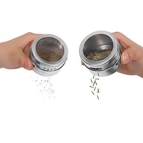 Two hands pouring salt and pepper from shakers.